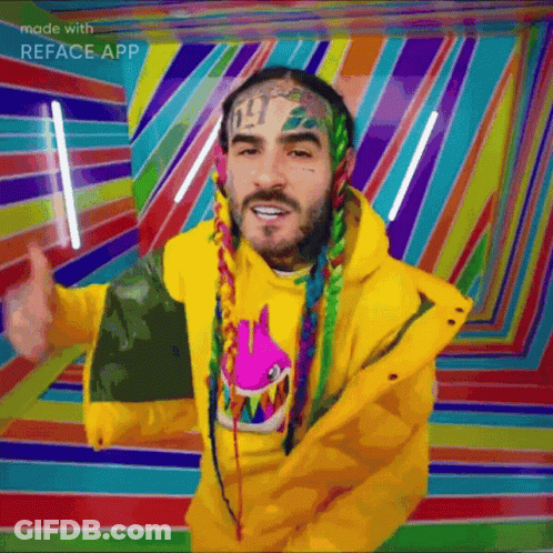 A Man With Dreadlocks Is Wearing A Yellow Jacket And Giving A Thumbs Up GIF