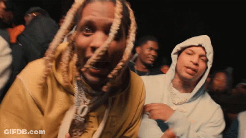 A Man With Dreadlocks Is Wearing A Yellow Sweatshirt That Says Eve GIF