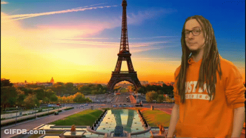 A Man With Dreadlocks Is Wearing An Orange Shirt That Says Just A Thing GIF