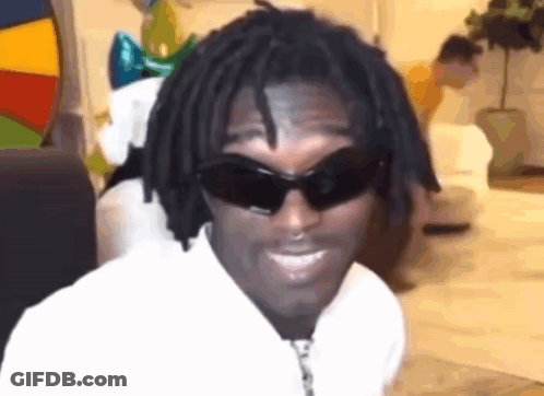 A Man With Dreadlocks Is Wearing Sunglasses And A White Shirt . GIF