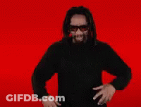 A Man With Dreadlocks Is Wearing Sunglasses And Singing Into A Microphone With The Letter O Above Him GIF