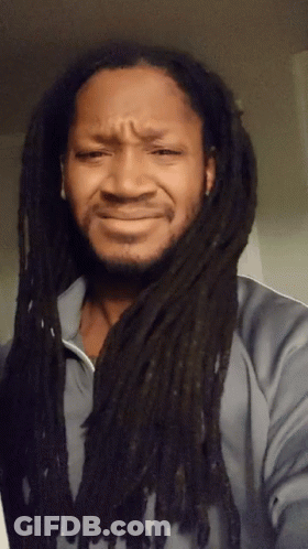A Man With Dreadlocks Making A Sad Face GIF