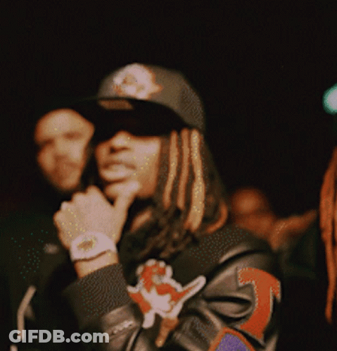 A Man With Dreadlocks Wearing A Hat And A Jacket With The Number 3 On It GIF