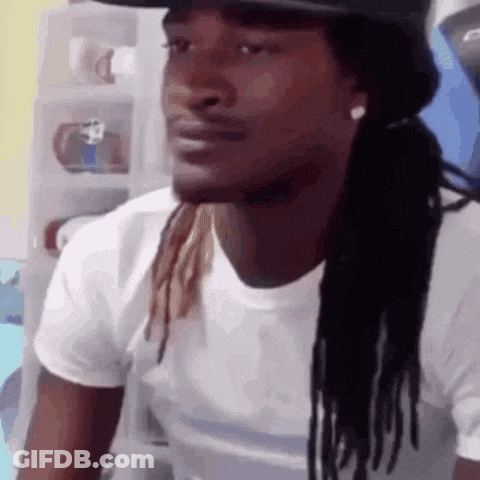 A Man With Dreadlocks Wearing A Hat And A White Shirt GIF