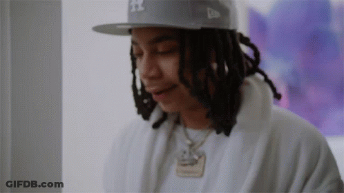 A Man With Dreadlocks Wearing A Hat That Says Ny On It GIF