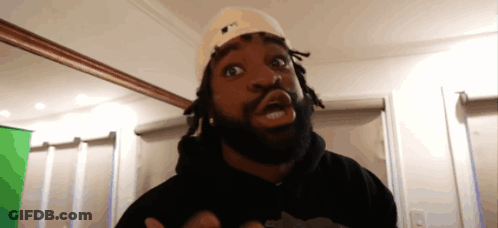 A Man With Dreadlocks Wearing A Hat That Says Ny GIF
