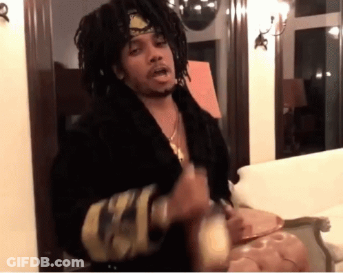 A Man With Dreadlocks Wearing A Headband And A Black Robe GIF