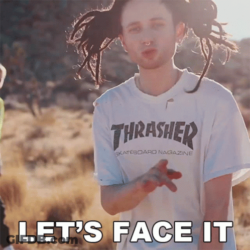 A Man With Dreadlocks Wearing A Thrasher Shirt GIF