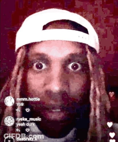 A Man With Dreadlocks Wearing A White Baseball Cap GIF