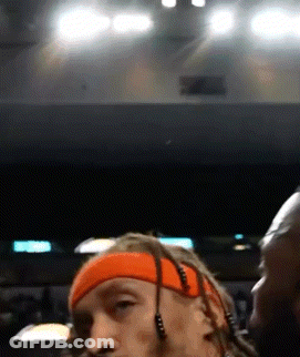 A Man With Dreadlocks Wearing An Orange Headband And Earbuds GIF