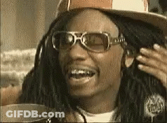 A Man With Dreadlocks Wearing Sunglasses And A Hat Is Smiling GIF