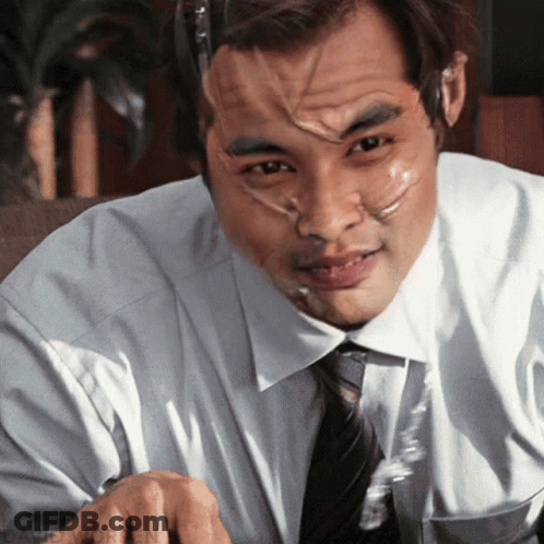 A Man With Duct Tape On His Face Is Sitting At A Desk GIF