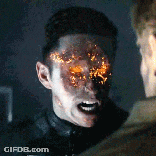 A Man With Flames Coming Out Of His Face Is Talking To Another Man GIF