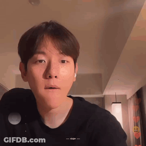 A Man With Freckles On His Face Is Wearing A Black Shirt That Says Xhan On It GIF