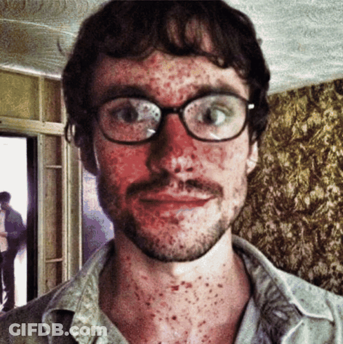 A Man With Glasses And A Beard Has Spots On His Face GIF