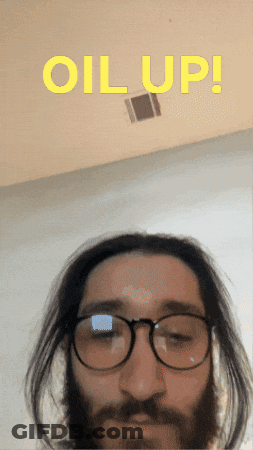 A Man With Glasses And A Beard Has The Words " Oil Up " Above Him GIF