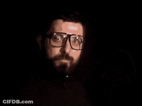 A Man With Glasses And A Beard Holding A Video Game Controller With The Words Time For Video Games Below Him GIF