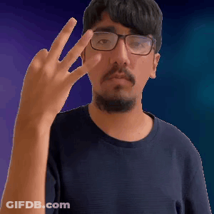 A Man With Glasses And A Beard Is Giving A Middle Finger GIF