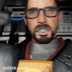 A Man With Glasses And A Beard Is Holding A Box In His Hand GIF
