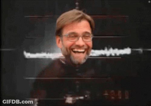 A Man With Glasses And A Beard Is Laughing GIF