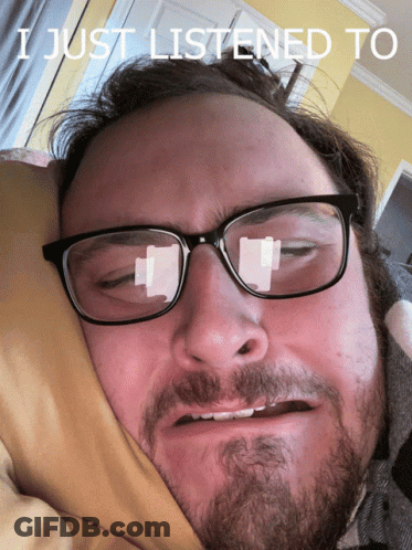 A Man With Glasses And A Beard Is Laying In Bed With The Words I Just Listened To Written Above Him GIF