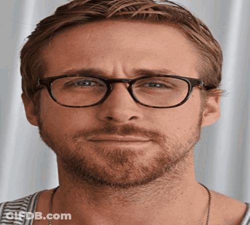 A Man With Glasses And A Beard Is Making A Face GIF