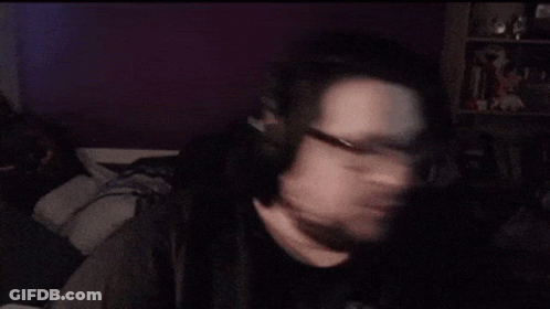 A Man With Glasses And A Beard Is Making A Face GIF