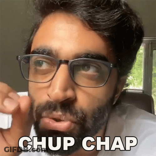 A Man With Glasses And A Beard Is Making A Funny Face And Saying Chup Chap GIF