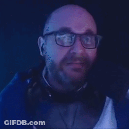 A Man With Glasses And A Beard Is Making A Funny Face And Saying Pass . GIF