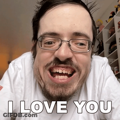 A Man With Glasses And A Beard Is Making A Funny Face And Says I Love You GIF
