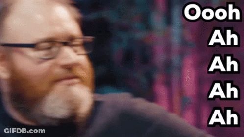 A Man With Glasses And A Beard Is Making A Funny Face And The Words Oooh Ah Ah Ah Ah Are Behind Him GIF