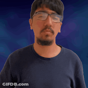 A Man With Glasses And A Beard Is Making A Gesture GIF