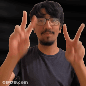 A Man With Glasses And A Beard Is Making A Peace Sign GIF