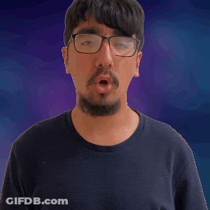 A Man With Glasses And A Beard Is Making A Surprised Face GIF