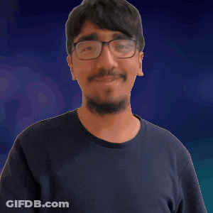 A Man With Glasses And A Beard Is Pointing At Something GIF
