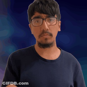 A Man With Glasses And A Beard Is Pointing His Finger GIF