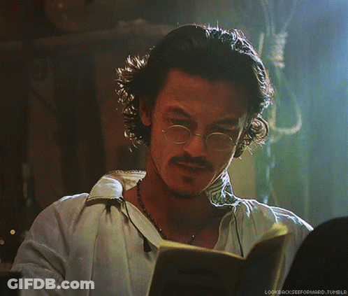 A Man With Glasses And A Beard Is Reading A Book With The Words Lookbackzeeforward.tumblr Below Him GIF