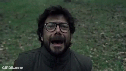 A Man With Glasses And A Beard Is Screaming In A Field . GIF