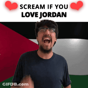 A Man With Glasses And A Beard Is Screaming In Front Of A Flag That Says Scream If You Love Jordan GIF