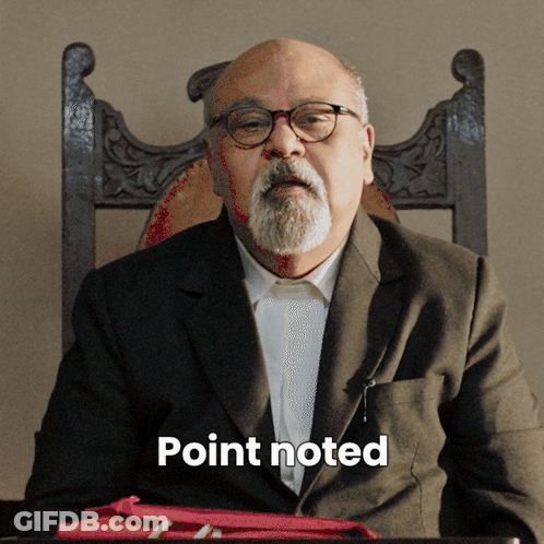 A Man With Glasses And A Beard Is Sitting In A Chair With The Word Point Noted Written Below Him GIF