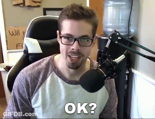 Man With Glasses And Beard Sitting In Front Of Microphone Saying Ok GIF