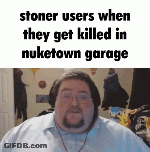 A Man With Glasses And A Beard Is Standing In Front Of A Sign That Says Stoner Users GIF