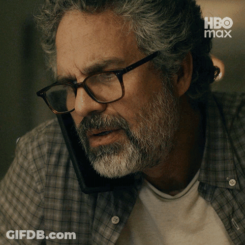 A Man With Glasses And A Beard Is Talking On A Cell Phone With The Caption Yeah It 'S Him GIF