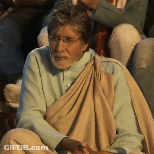 A Man With Glasses And A Beard Is Wearing A Blue Shirt GIF