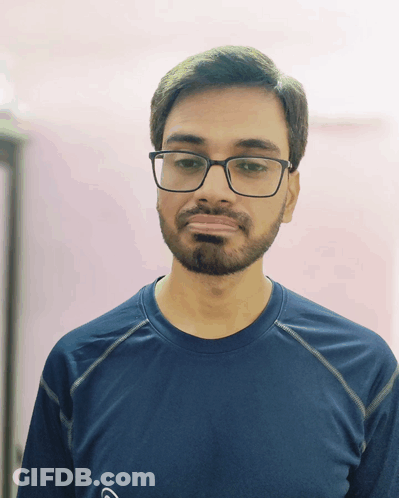 A Man With Glasses And A Beard Is Wearing A Blue Shirt With The Letter G On It GIF