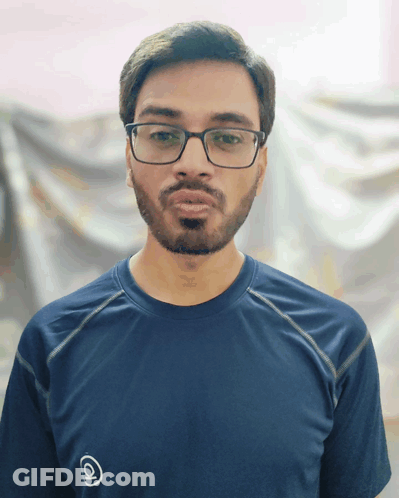 A Man With Glasses And A Beard Is Wearing A Blue Shirt With The Letter Q On The Front GIF