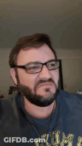 A Man With Glasses And A Beard Is Wearing A Blue Shirt With The Word Rum On It GIF