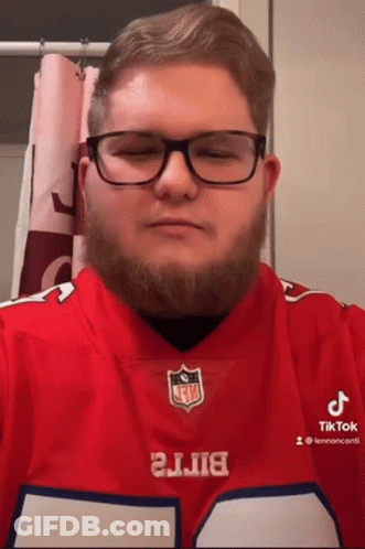 A Man With Glasses And A Beard Is Wearing A Buffalo Bills Shirt GIF