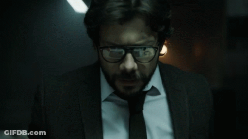 A Man With Glasses And A Beard Is Wearing A Suit GIF