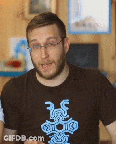 A Man With Glasses And A Beard Is Wearing A T-Shirt With A Blue Design GIF